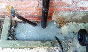 Bournemouth Drains24 engineer unblocking a kitchen drain and removing grease buildup