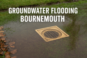 Groundwater flooding around a garden drain in Bournemouth, showing soil saturation and signs of slow drainage.